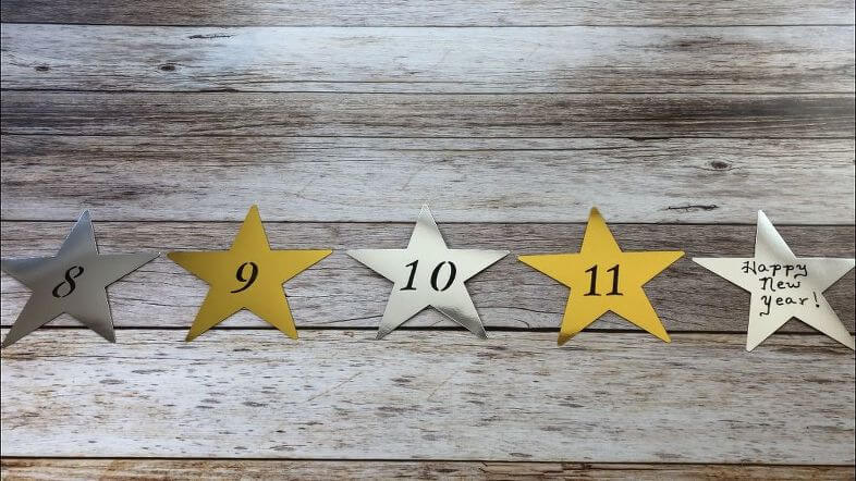 I bought silver and gold stars from Dollar Tree and stenciled numbers onto each star. The numbers represent the time of the evening... 8pm, 9pm, 10pm, 11pm, "Happy New Year" = Midnight.