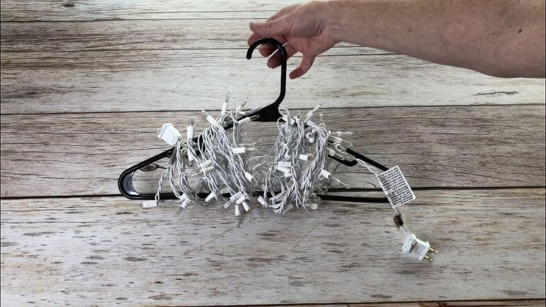 Use a hanger to wind lights up. Hang them up until next year.