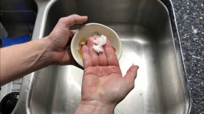 Place 1 teaspoon coconut oil and 1 teaspoon sugar (or salt) in a bowl. Mash together with a fork until all the sugar is mixed into the coconut oil. Rub all over your hands and rinse off. The sugar exfoliates your skin while the coconut oil moisturizes it.