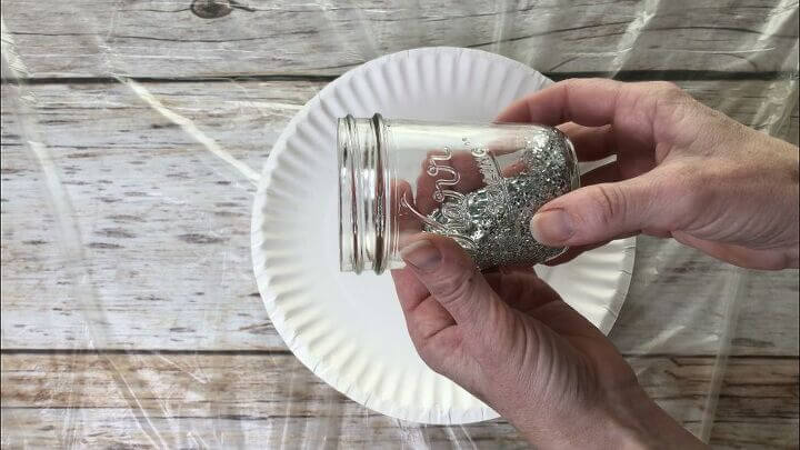 Pour glitter into the jar and twist the jar making sure the glitter sticks to the hairspray inside. Dump out the extra glitter and let it dry completely.