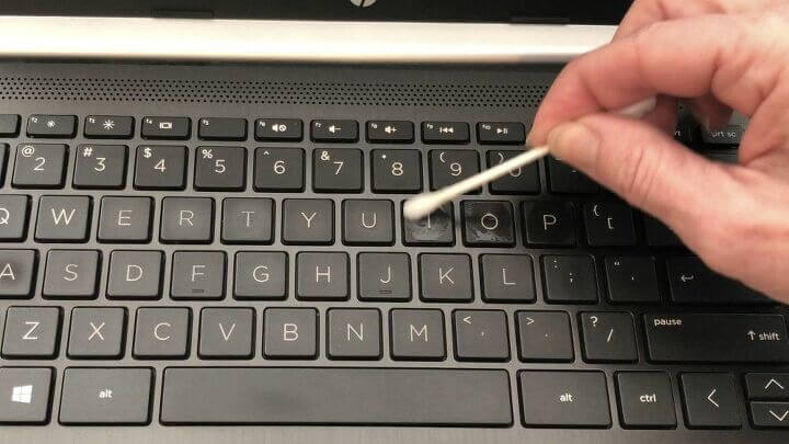 Make sure your computer is off. Dip a q-tip in rubbing alcohol and rub onto your keys to clean them.