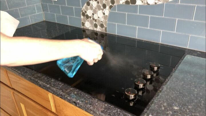 Spray rubbing alcohol onto your stove top and other surfaces to clean, disinfect, and remove grease.