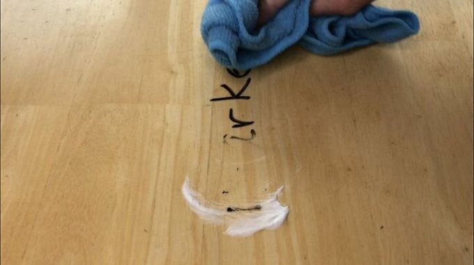 Place regular (not gel) toothpaste on a microfiber cloth and buff that marker right off the wood.