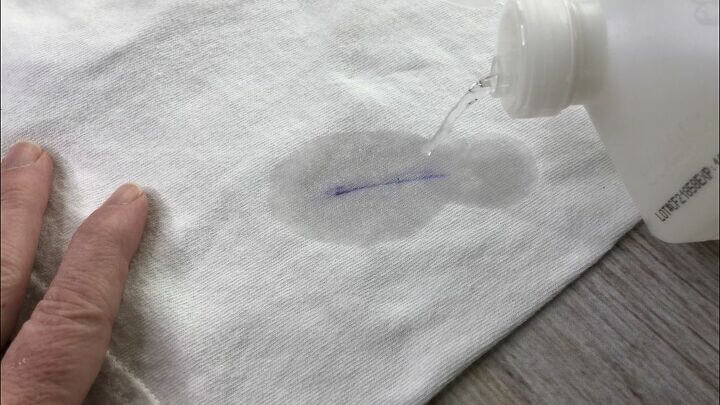 Squirt rubbing alcohol onto the ink stain and let it sit 10 minutes or more. Blot at the stain with a damp cloth and see if the ink is gone. If not repeat until the ink is removed. Once all of the ink is gone, launder.