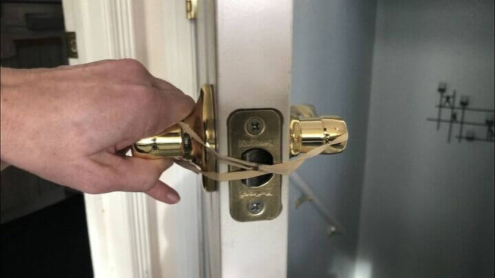 Hook a wide rubber band around one handle, crisscross the rubber band and hook the other onto the other handle. This will slow down the door when it gets closed so it doesn't slam.
