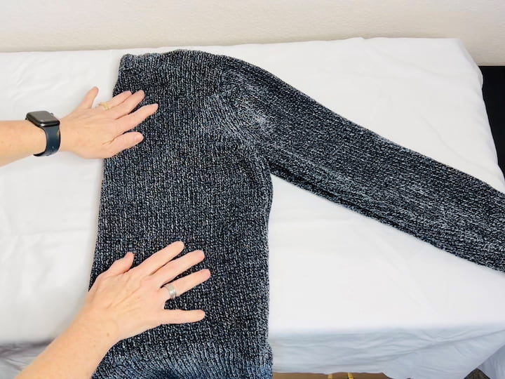 Here's how you can hang a sweater. Simply fold the sweater in half then move it diagonally. Flip one end of the sweater over the hangar and tuck it in and then flip the other side sweater side over and tuck it in.