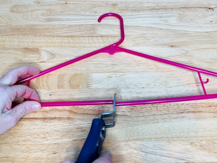 Take a plastic hanger and cut the bottom in half. Open up the bottom and slide paper towels onto the hanger, then you can hang the paper towels where you need them. I have hooked this to my workbench and now it's really easy to grab towels when I need them to clean up a mess or wipe up my counters.