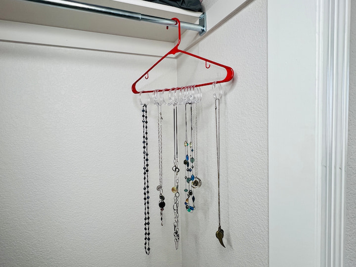 Clip your jewelry into place on the shower curtain rings. These will hang nicely in your closet and won't get tangled. 