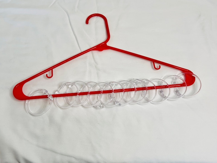 Here are a bunch of ideas using just plastic clothes hangers and some shower curtain rings. You can also use an old wooden hanger if you have one handy. Open the shower curtain rings and place them on the bottom of the hangers. You can use as many or as few as you like. 