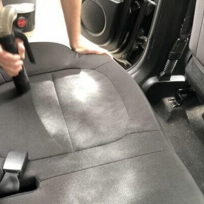 Sprinkle your car seats, floor, back, etc with baking soda. Let sit in the car for 30 minutes and then vacuum it out. This will help neutralize and deodorize your car.