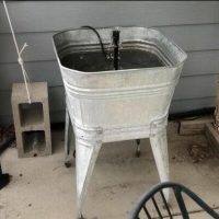 This fountain was so easy to create. The washtub is my grandparents but you could easily use a flower pot. I bought a fountain kit at Walmart and now I have a nice fountain on my patio. You can find the full tutorial here - Easy and Inexpensive Water Fountain/Feature