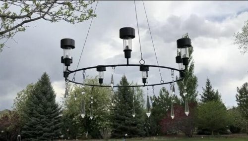 I found this fun taper candle holder at IKEA. I siliconed solar lights into the taper candle holders and let that dry. I added some dangling crystals I found at the thrift store for added sparkle. I hung this in our tree. It hangs low enough to get plenty of light.