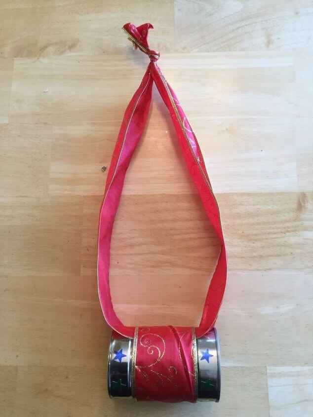 For this bird feeder, I glued some ribbon around a recycled can, and I made a loop to hang the bird feeder from. I added some star stickers but you could paint or decorate the can however you want.