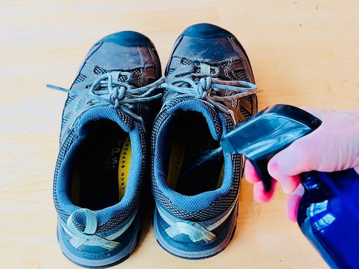 Spraying vinegar in shoes