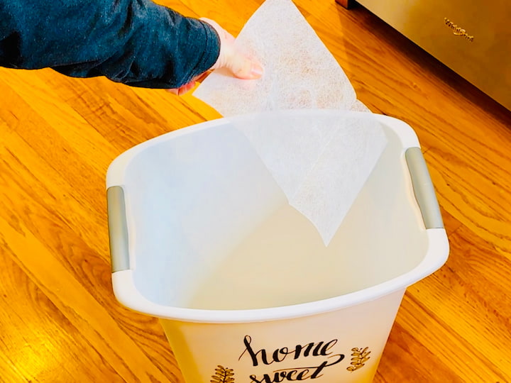 placing dryer sheet in a trashcan