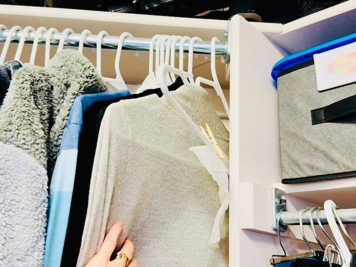 Clothes pinning a dryer sheet to a hanger and hang in closet