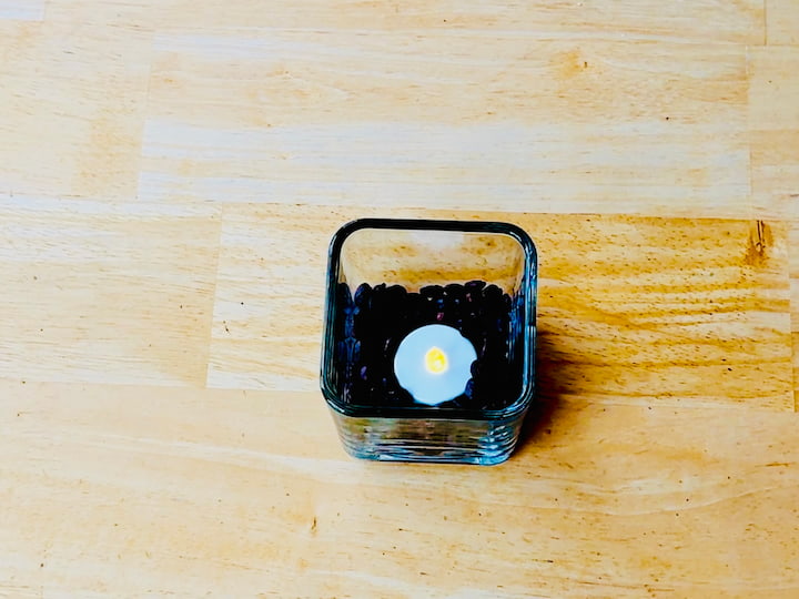 coffee and battery operated tea light in a candle holder