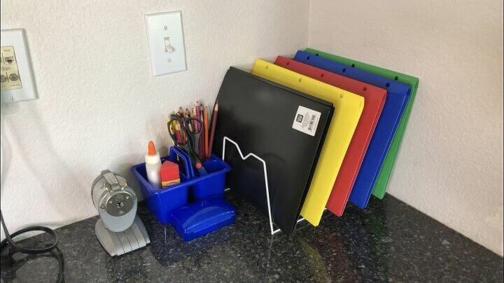 We used a dish rack to homework folders and keep them organized. We also made a portable supply container with colored pencils, glue, and scissors that can be moved out to the table when working and put away when not in use. You can see my daughter using it in the picture above.