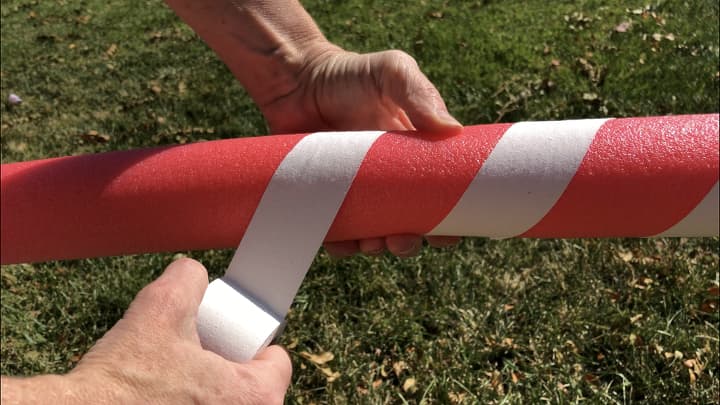 Candy Canes - I wrapped white athletic tape that I got from Dollar Tree around 2 red pool noodles.