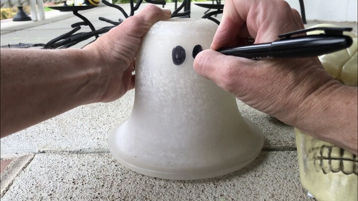 Glowing Ghost - I bought 2 glass lamp shades at a thrift store. I use a permanent marker to make some eyes.
