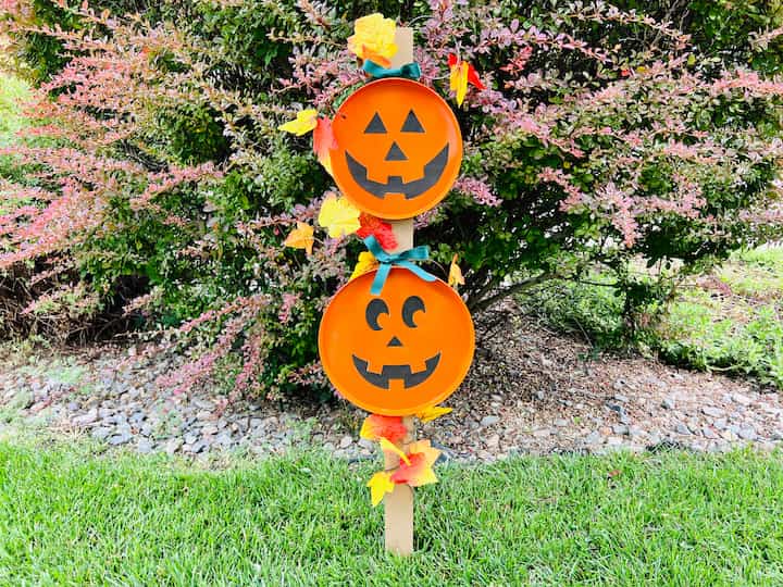 Set this cute pumpkin sign anywhere you like. If you are going to put it in the elements you might want to consider giving the face a coat of dishwasher safe Mod Podge to protect it, or you could paint on the face with multi-surface paint.