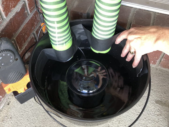 Add some water to the bottom of a plastic cauldron.  Tape the legs upside down into the cauldron.  Add an atomizer to the cauldron to create the misting effect.