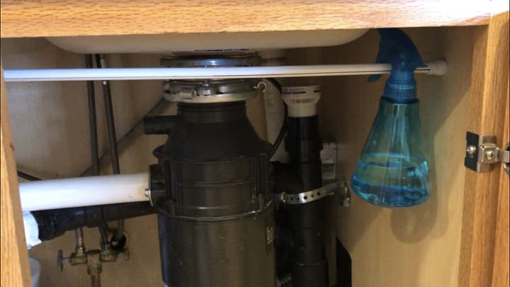 I bought a tension rod, and hung some of my spray bottles from that to give me more space. The one you see here as rubbing alcohol in it for disinfecting. I also keep a spray bottle of dish soap and water as well as vinegar and water.
