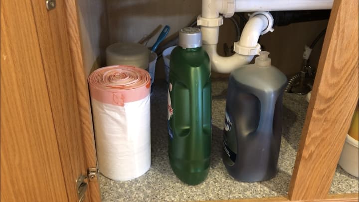 I placed only the items I needed to have back in which on this side included - large trash bags (my small container of grocery bags is right behind it), dishwasher, and dish soap. A few items like back up dish scrubbing supplies are in a container in the very back.