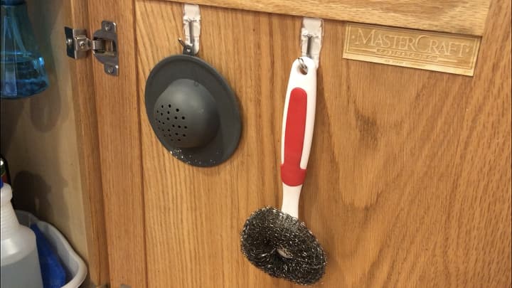 I used a couple command hooks on the back of the cabinet door to hold some supplies I grab once and a while for cleaning.