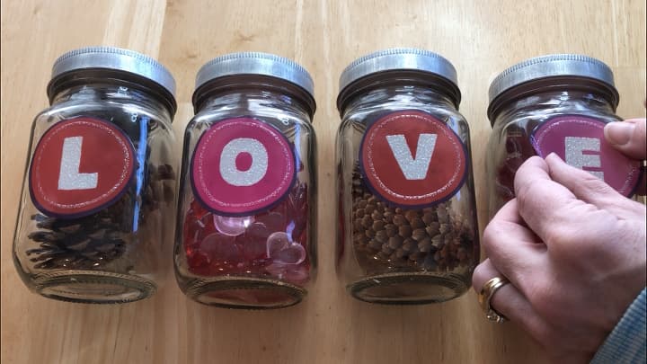 Mason Jar Display - Fill mason or recycled jars with items. I used pine cones, and Dollar Tree heart table scatter. You could also fill them with candles, candy, etc.I placed window clings on each mason jar.