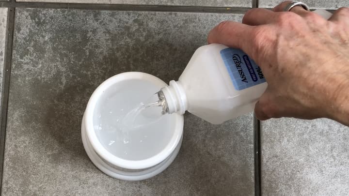 Add a little baking soda to the bottom of your toilet brush stand. Fill the rest of the stand with rubbing alcohol, and place your toilet brush inside the stand.