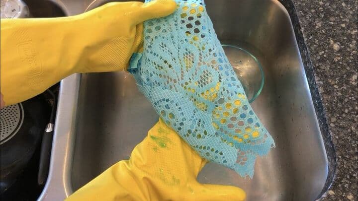 I dumped out the water, and rung out the fabric. If you wanted you could save the water and dye more doilies or other fabric. I made sure to use rubber gloves so I wouldn't dye my hands.