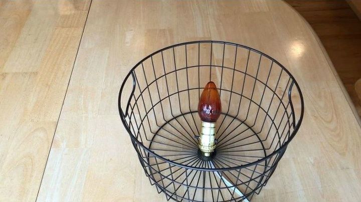 I found this basket at Walmart on clearance for $2 and since it had a hole in the bottom I knew exactly what I wanted to do with it. I bought a light socket kit and followed the directions on it to put the light together utilizing the hole in the basket.