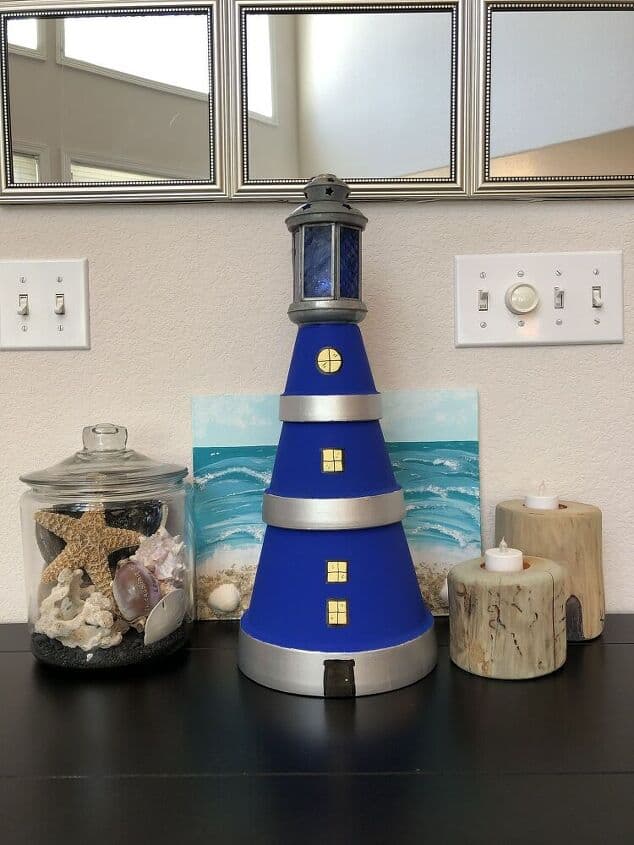 I just love the beach and I’ve been looking for creative ways to incorporate beachy decor into my home. This flower pot lighthouse is the perfect project to accent my shell collection! With just a few easy to find materials you can have your own nifty flower pot lighthouse in under an hour or two. This project is so easy that you don’t need any crafting experience in order to do it yourself. Check out my step by step guide and get started!
