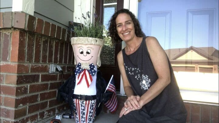 Finished Uncle Sam terracotta flower pots on front steps with Chas.