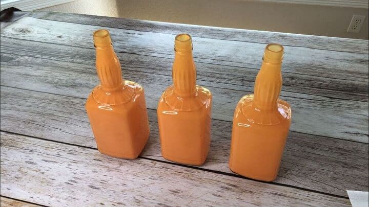 Here's a quick picture of the painted bottles.  You'll want to leave the top open so that the paint can dry inside.