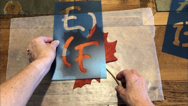 Using the maple leaves first, I placed a stencil letter "F" onto the leaf.