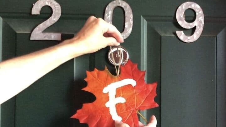 I cut a piece of twine and hot glued that into place so that I could hang my fall leaf decoration on my door.  