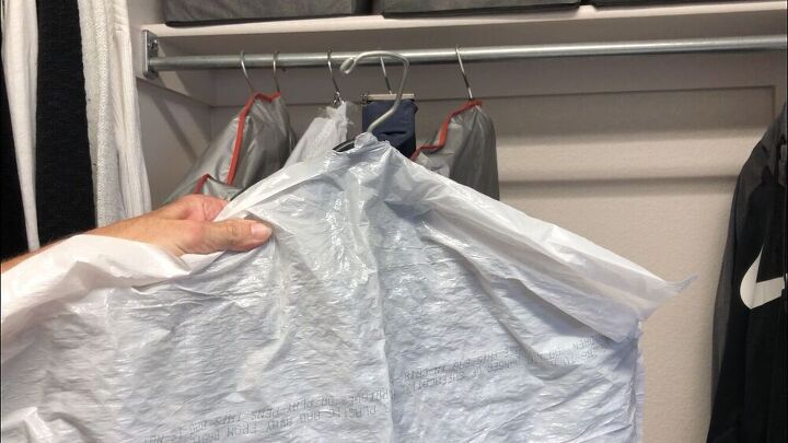 You can buy garment bags, or you can poke a hole in the bottom of a garbage bag, place the hanger through the hole, and you have an inexpensive garment bag. 