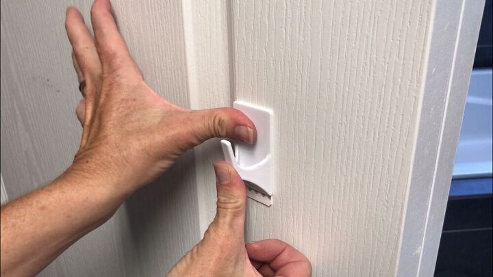 Place adhesive hooks on a door or wall.