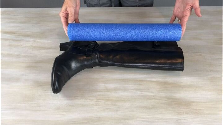 Measure a pool noodle for how long it needs to be in a boot and cut it with a knife or saw.