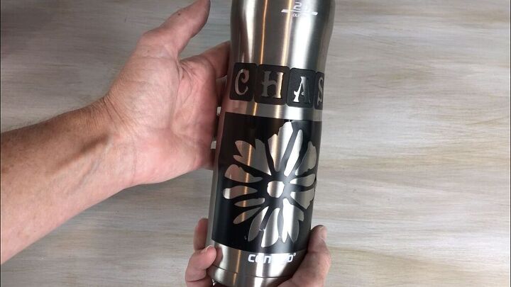 I placed an adhesive stencil onto a stainless steel water bottle.