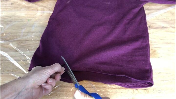 I bought a 5T purple long sleeve shirt from Walmart. I cut zig zags on the bottom of the shirt.