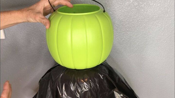 I hot glued another pumpkin bucket to the top for a head. You could use the face of the pail or place it backwards as I did. I'll left mine blank but you could also draw or paint a face on if you like.