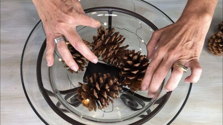 I placed some of the cinnamon pine cones in the bowl, twisted the LED light strand among the pine cones, and then repeated adding pine cones and twisting in the lights.