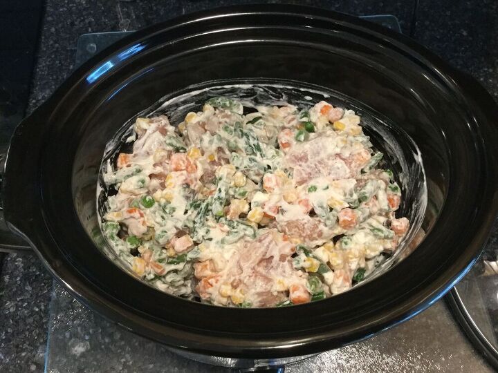 Mix cream of chicken soup, chicken, and frozen vegetables in crock pot. Cook on low for 4-5 hours until chicken is tender. Mix in sour cream and flour. Cover and heat on high for 20 minutes.