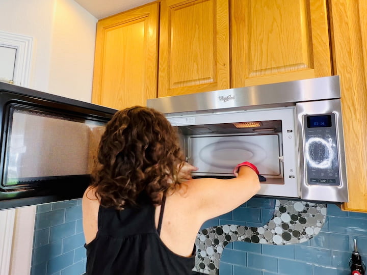 Wipe down refrigerator, handles, and shelves with soapy water. Place a bowl of lemon juice and vinegar in the microwave, heat for 5 minutes, then wipe down interior. Clean oven's exterior, knobs, and keypad. Use self-cleaning mode if applicable.