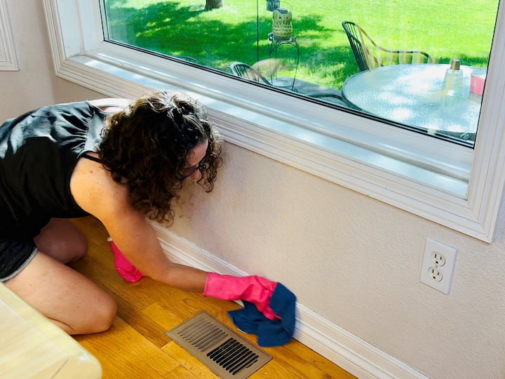 Mix warm water and a tablespoon of Dawn dish soap (or Castile soap). Wipe down moldings, walls, light switches, electrical outlets, and baseboards. Use microfiber cleaning cloths with just water to clean windows, followed by a second cloth to remove streaks.