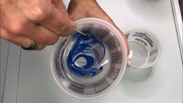 Next I divided the epoxy into 3 smaller bowls, and reserved plenty of clear in the orignal container.  I added a small drop of Folk Art Acrylic paint in the colors True Blue, Ocean View, and Titanium White to each container.  