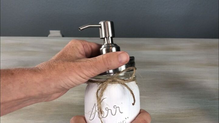 I purchased stainless soap dispenser kits online.  I put them together and twisted them onto the mason jars.